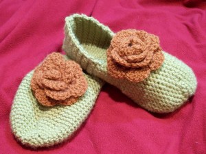 Crochet green slippers with roses