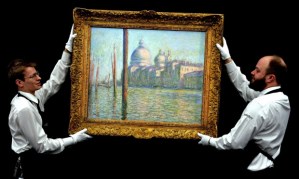 Sotheby's staff prepare to hang Claude Monet's Le Grand Canal, which sold for £23.7m. Photograph: John Stillwell/PA