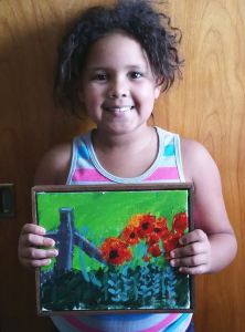 Hannah with framed poppy painting